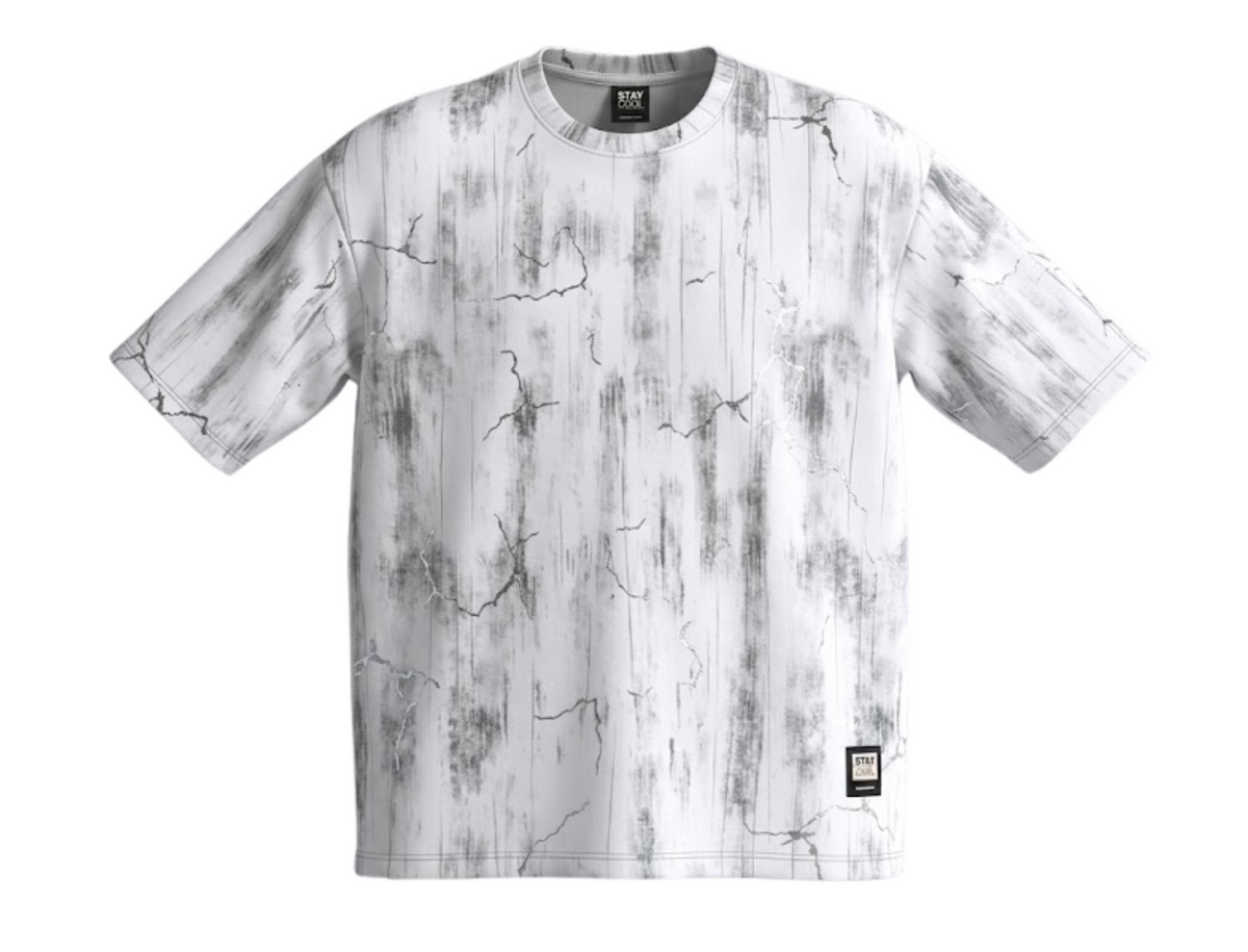 A short-sleeve crewneck t-shirt featuring a vertical distressed wood-grain pattern in white and gray, with a small black square brand patch on the lower right hem.